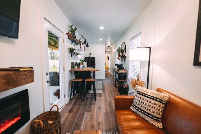 Open kitchen area with orange sofa