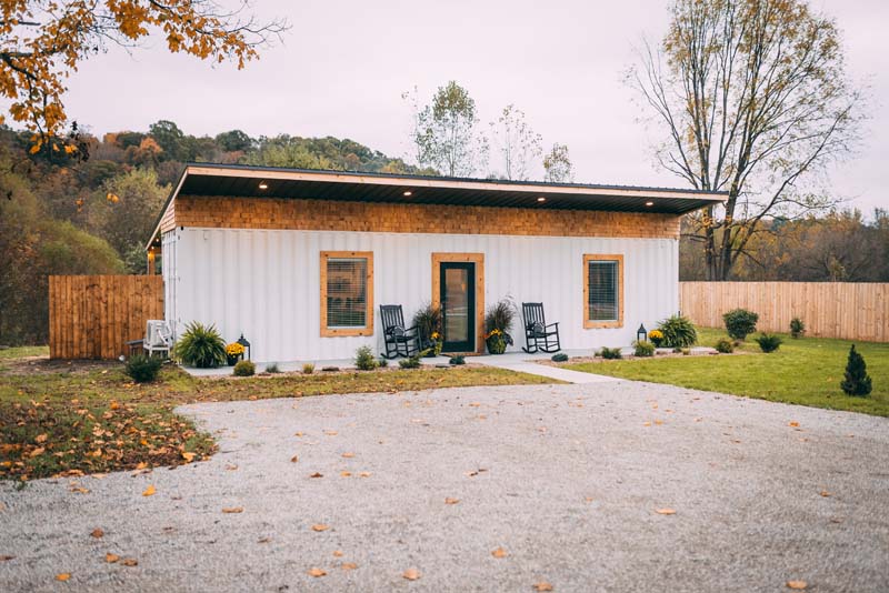 Luna Cottage, a white shipping-container tiny house with a covered porch